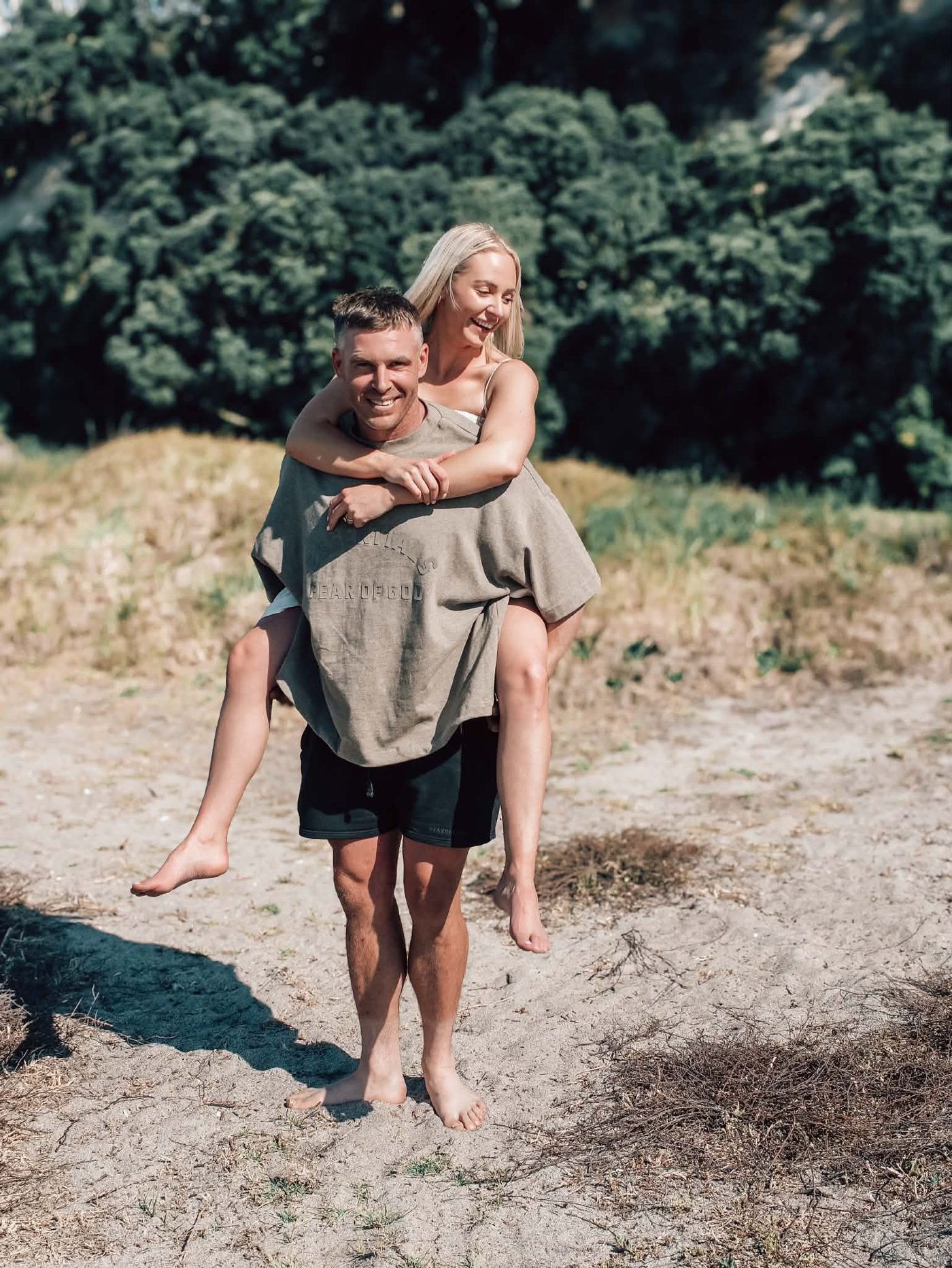 Josh giving Lacy a piggyback, both laughing