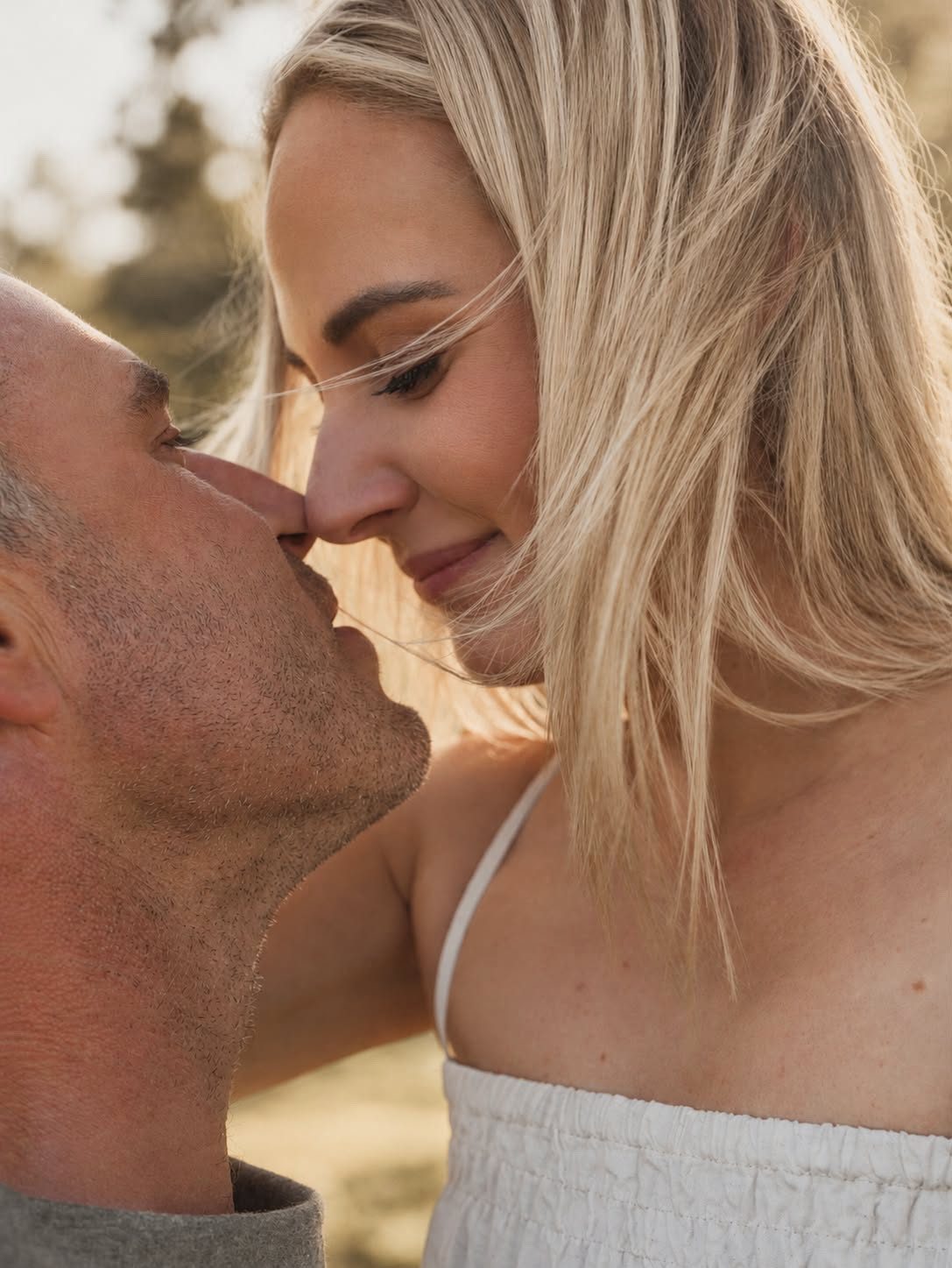 Lacy and Josh in a close embrace, noses touching